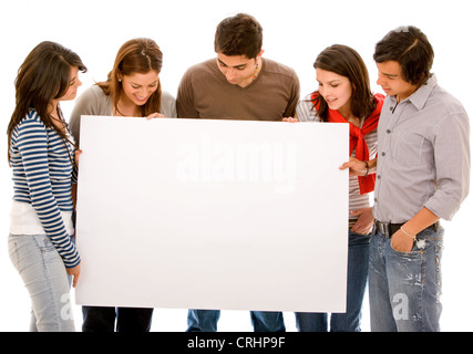 group of friends looking at a blank white sign Stock Photo