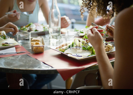 Friends enjoying meal in cafe, cropped Stock Photo