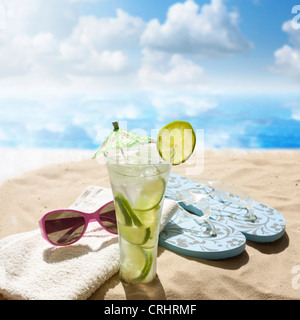 sunglasses drink in sand on beach at sea holiday concept Stock Photo