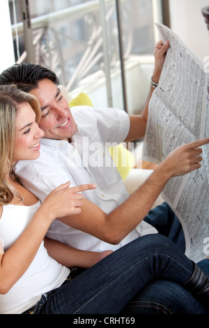 couple at home reading the newspaper