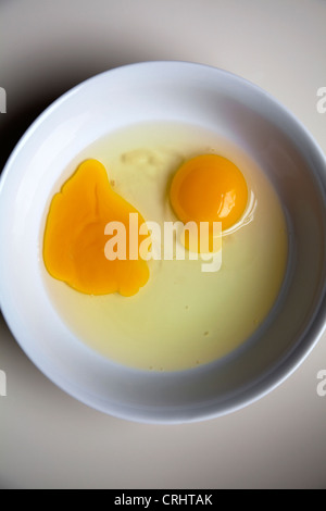Two Opened eggs in bowl Stock Photo