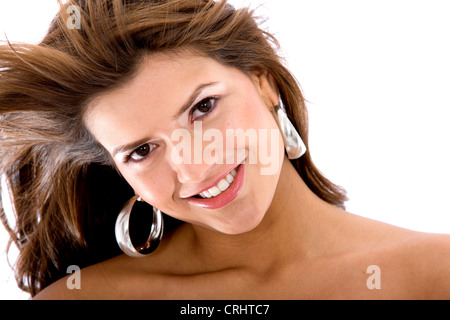 young beautiful brown-haired woman with big earrings, blowing hair Stock Photo