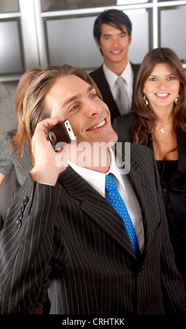 business man portrait in an office smiling and talking on the phone Stock Photo
