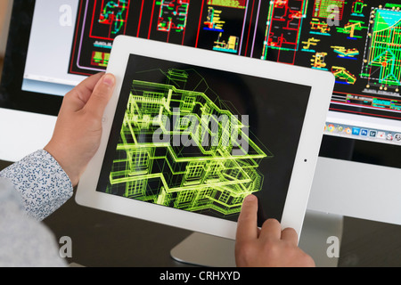 Architect using iPad CAD Computer Aided Design application to model 3D layout design of new house Stock Photo