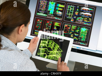 Architect using iPad CAD Computer Aided Design application to model 3D layout design of new house Stock Photo