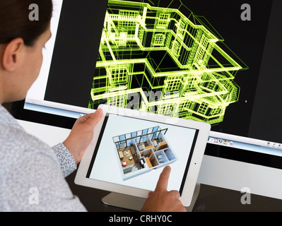 Architect using iPad CAD Computer Aided Design application to model 3D layout design of new house Stock Photo