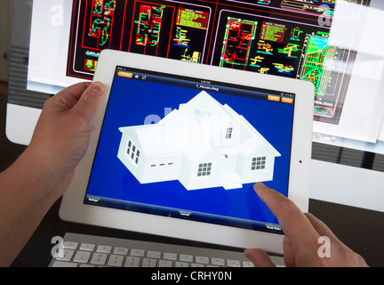 Architect using iPad CAD Computer Aided Design application to model 3D layout design of new house Stock Photo