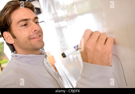 male student writing on the blackboard during a seminar Stock Photo