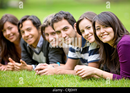 happy group of friends smiling outdoors in a park Stock Photo