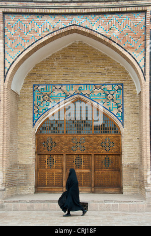 Muslim woman wearing traditional black hijab walking in Qazvin, Iran Stock Photo