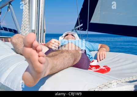 man relaxing on sailboat Stock Photo