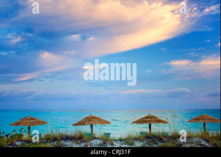 Reed umbellas and sunrise clouds. Turks and Caicos. Providenciales Stock Photo