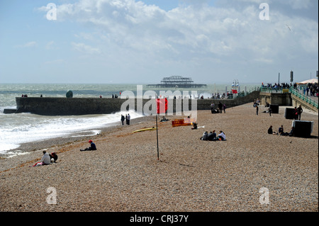 Red Danger flag flying on Brighton beach Sussex UK signalling that the sea is too rough to go in swimming Stock Photo