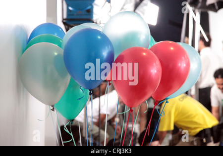 It's a photo of many colorful balloons attached together to tiny ropes. They are red blue green and white. It's for a birthday