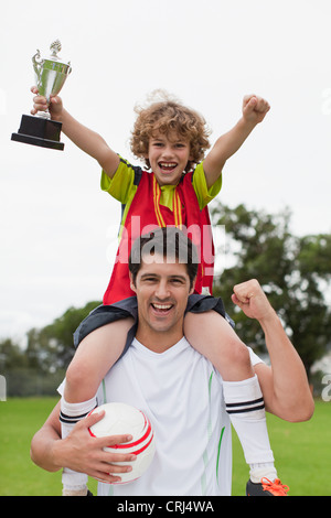 trophy carrying coach child alamy middle school cheering celebrating soccer team girl