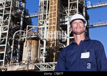 Worker standing at oil refinery Stock Photo