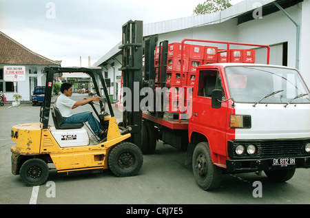 Loading a van with boxes of Coca-Cola brand in Bali Stock Photo