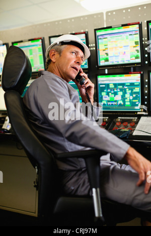 Man working in security control room Stock Photo