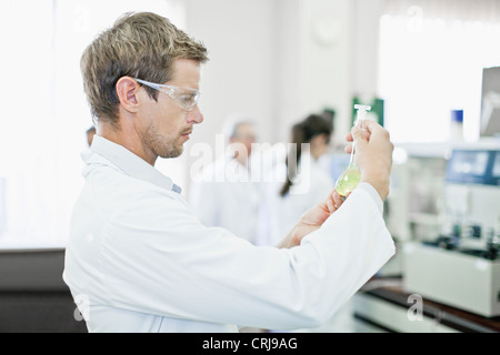 Scientist examining liquid in lab Stock Photo