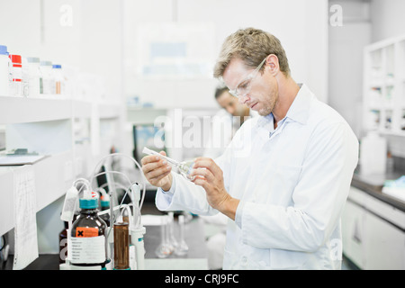 Scientist examining liquid in lab Stock Photo