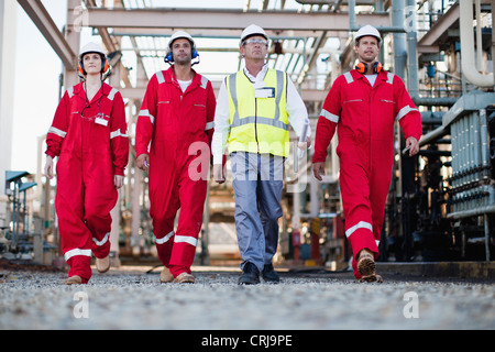 Workers walking at chemical plant Stock Photo