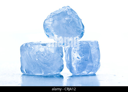 ice cubes shot on reflective white surface Stock Photo