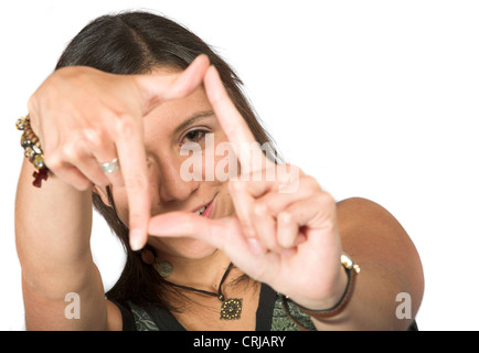 young girl looking through a frame formed by her fingers Stock Photo