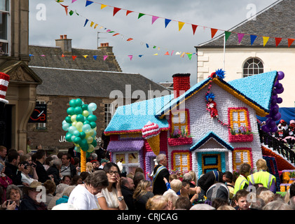 Floats or 'lorries' in the procession through the streets of Lanark on Lanimer Day  which takes place there in June of each year Stock Photo