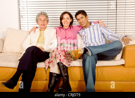 family portrait sitting on a sofa at home Stock Photo