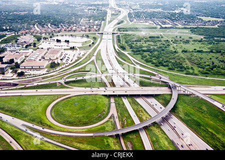 aerial view complex stacked 4 level cloverleaf highway interchange & suburban development with flooding outside Dallas Texas Stock Photo