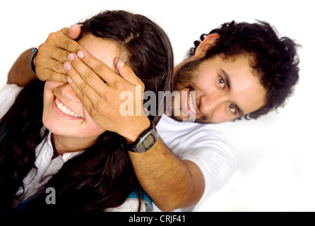man covering a girls eyes to see if she can guess who is behind her Stock Photo