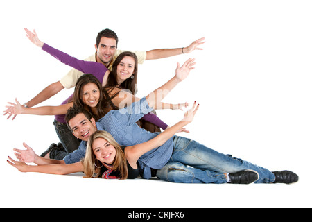 five smiling young people posing on the floor huddled together with their arms stretched out Stock Photo