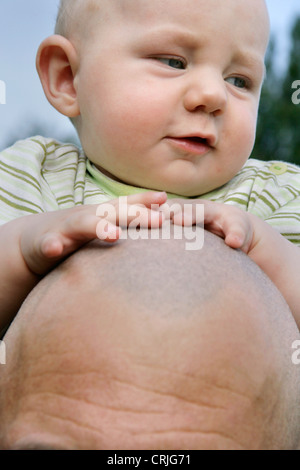 father carrying his child on the shoulders, Germany Stock Photo