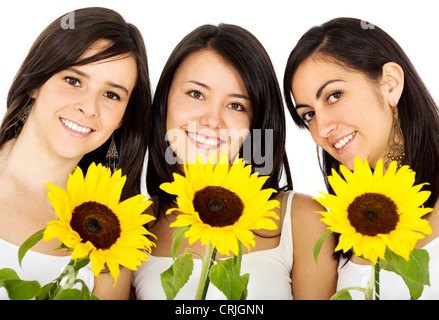 three smiling girls with three sun flowers Stock Photo