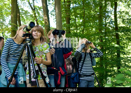 group of girls wathing birds with field glasses Stock Photo