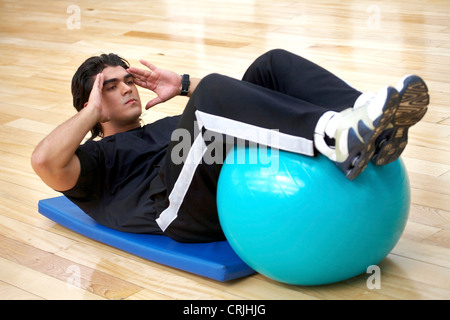 man at the gym doing abdominal exercises Stock Photo