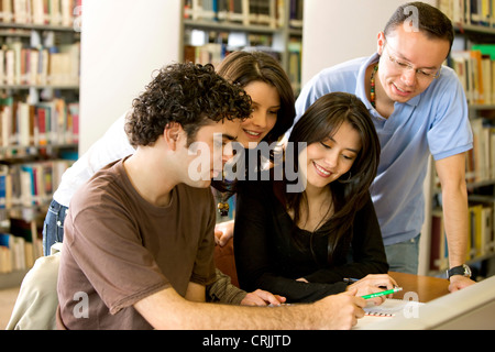 library students smiling and doing group coursework Stock Photo