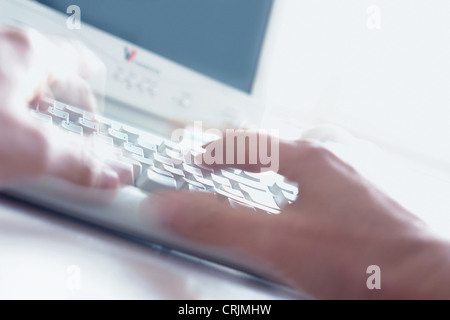 fingers typing on PC keyboard Stock Photo