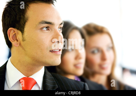 businessman with two more people in an office smiling - small team Stock Photo