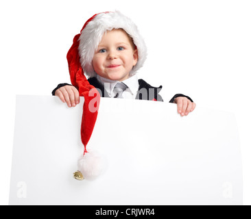 smiling young boy with a Santa cap holding an empty white panel Stock Photo