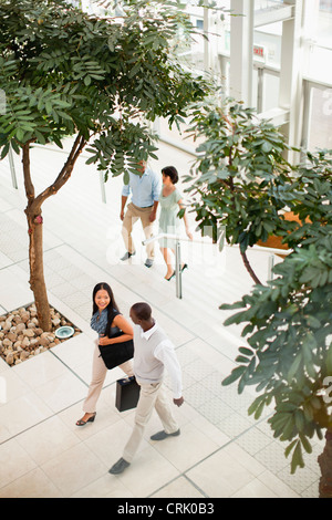 Business people walking in lobby Stock Photo