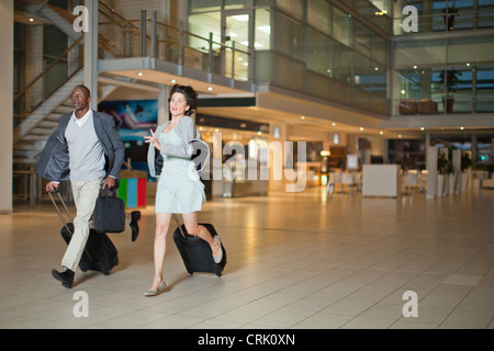 Business people running in lobby Stock Photo