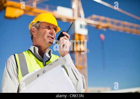Worker using walkie talkie on site Stock Photo