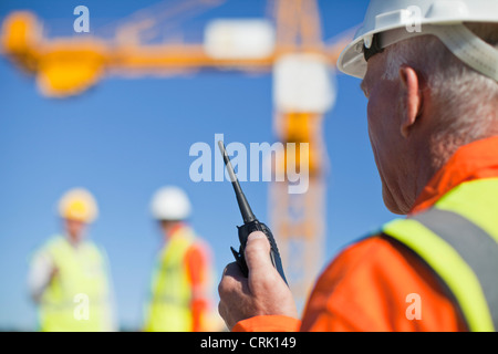 Worker using walkie talkie on site
