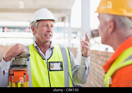 Workers talking at construction site Stock Photo