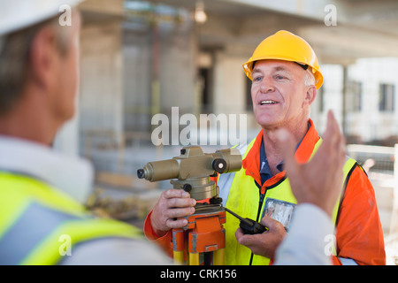 Workers talking at construction site Stock Photo