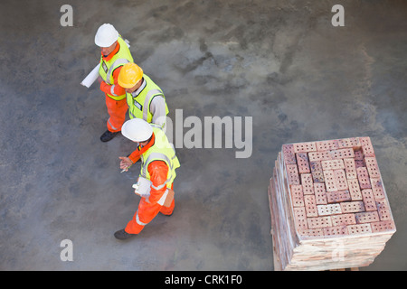Workers walking at construction site Stock Photo
