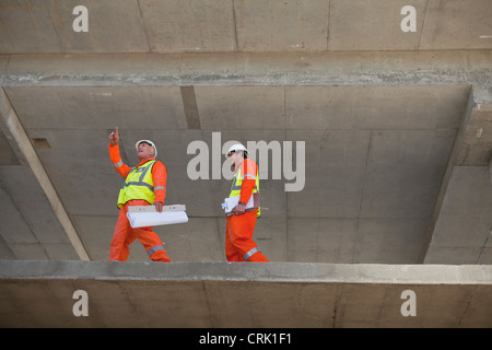 Workers walking at construction site Stock Photo