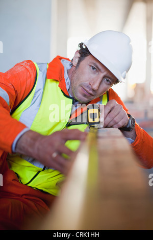 Worker measuring brick on site Stock Photo