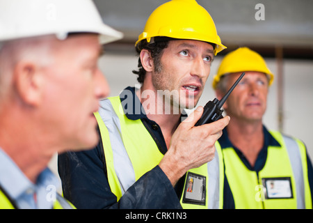Workers using walkie talkie on site Stock Photo
